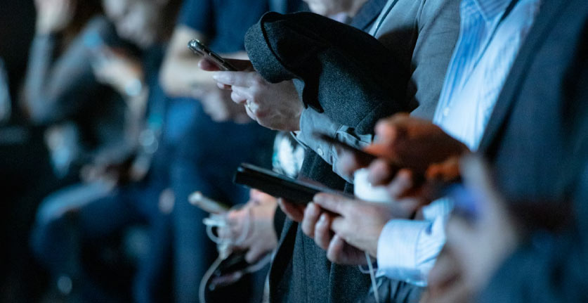 working class people holding mobile phones